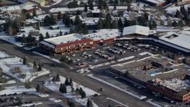 5.5K aerial stock footage orbit small town strip mall with winter snow in Park City, Utah Aerial Stock Footage | AX126_163