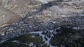 5.5K aerial stock footage of flying by the small mountain town of Park City in wintertime, Utah Aerial Stock Footage | AX126_167E