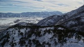 5.5K aerial stock footage pan and fly over snowy Wasatch Range mountain ridge in winter, Utah Aerial Stock Footage | AX126_188E