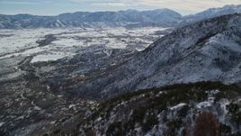 5.5K aerial stock footage fly over snowy Wasatch Range slopes to approach Heber Valley, Utah Aerial Stock Footage | AX126_195