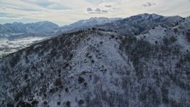 5.5K aerial stock footage approach and fly over snowy Wasatch Range mountain in winter to reveal Midway, Utah Aerial Stock Footage | AX126_196E