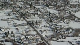 5.5K aerial stock footage of flying over homes with snow on rooftops in winter, Midway, Utah Aerial Stock Footage | AX126_208