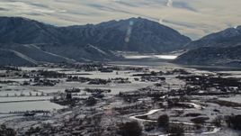 5.5K aerial stock footage orbit Deer Creek Reservoir by Heber City with winter snow, Utah Aerial Stock Footage | AX126_213