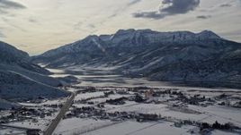 5.5K aerial stock footage approach frozen shore of Deer Creek Reservoir and mountains in winter, Heber City, Utah Aerial Stock Footage | AX126_220E