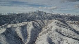 5.5K aerial stock footage of Mill Canyon Peak seen from the top of a snowy mountain in winter, Wasatch Range, Utah Aerial Stock Footage | AX126_234