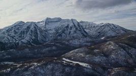5.5K aerial stock footage of rugged Mount Timpanogos with winter snow in the Wasatch Range of Utah Aerial Stock Footage | AX126_237E