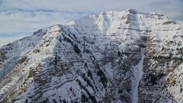 5.5K aerial stock footage of snowy, rugged slopes of Mount Timpanogos in winter, Utah Aerial Stock Footage | AX126_250E