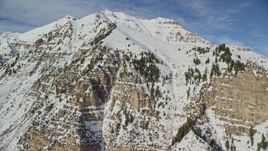 5.5K aerial stock footage of steep slopes of Mount Timpanogos with winter snow, Utah Aerial Stock Footage | AX126_255E