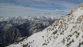 5.5K stock footage video pan across northern slopes of Mount Timpanogos to distant mountains in winter, Utah Aerial Stock Footage | AX126_269E