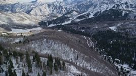 5.5K stock footage video fly over evergreens to approach Sundance Mountain Resort in winter, Utah Aerial Stock Footage | AX126_293E
