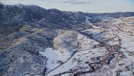 5.5K aerial stock footage approach riverside rural homes and mountains with light snow near Midway, Utah Aerial Stock Footage | AX127_007E