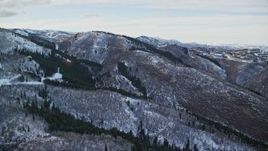 5.5K aerial stock footage orbit mountains with light snow and leafless trees in wintertime, Utah's Wasatch Range at sunset Aerial Stock Footage | AX127_017