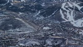 5.5K aerial stock footage of north of Park City, in the shadow of snowy mountains at sunset, Utah Aerial Stock Footage | AX127_026E