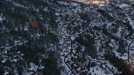 5.5K aerial stock footage approach residential neighborhoods in the shadow of a snowy mountain at sunset, Park City, Utah Aerial Stock Footage | AX127_043E