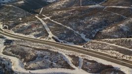 5.5K aerial stock footage approach I-80 with light traffic and winter snow at sunset, Wasatch Range, Utah Aerial Stock Footage | AX127_045E