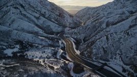 5.5K aerial stock footage approach I-80 through frigid Wasatch Range pass in wintertime at sunset, Utah Aerial Stock Footage | AX127_062E
