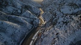 5.5K aerial stock footage approach freeway through the Wasatch Range with winter snow at sunset, Utah Aerial Stock Footage | AX127_064E