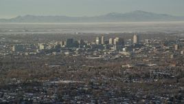 5.5K aerial stock footage of a wide orbit of Downtown Salt Lake City in winter at sunset, Utah Aerial Stock Footage | AX127_078