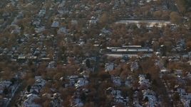 5.5K aerial stock footage of a Salt Lake City suburban neighborhood in winter at sunset, Utah Aerial Stock Footage | AX127_080