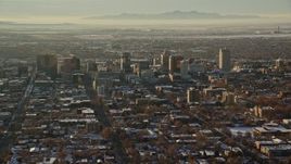 5.5K aerial stock footage of Downtown Salt Lake City with winter snow seen from east of the city at sunset, Utah Aerial Stock Footage | AX127_084E