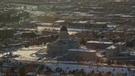 5.5K aerial stock footage of circling Utah State Capitol with winter snow on the grounds at sunset, Salt Lake City Aerial Stock Footage | AX127_088E
