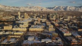 5.5K aerial stock footage orbiting Downtown Salt Lake City buildings with winter snow at sunset, Utah Aerial Stock Footage | AX127_095E