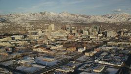 5.5K aerial stock footage orbit of Downtown Salt Lake City with winter snow at sunset, Utah Aerial Stock Footage | AX127_098