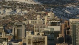 5.5K aerial stock footage orbit Downtown Salt Lake City buildings with Utah State Capitol and winter snow at sunset Aerial Stock Footage | AX127_102