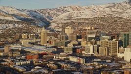 5.5K aerial stock footage of Downtown Salt Lake City and Utah State Capitol with winter snow at sunset Aerial Stock Footage | AX127_111E