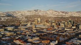 5.5K aerial stock footage of wide orbit of Downtown Salt Lake City with winter snow at sunset, Utah Aerial Stock Footage | AX127_113E