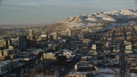 5.5K aerial stock footage of reverse view of Utah State Capitol, Downtown Salt Lake in winter at sunset Aerial Stock Footage | AX127_129