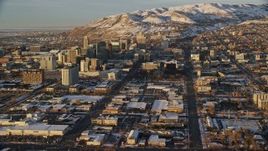 5.5K aerial stock footage of reverse view of Utah State Capitol, Downtown Salt Lake in winter at sunset Aerial Stock Footage | AX127_129E