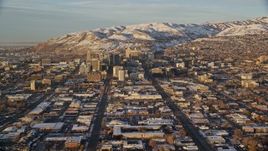 5.5K aerial stock footage of wide city streets through Downtown Salt Lake City at sunset with winter snow, Utah Aerial Stock Footage | AX127_132