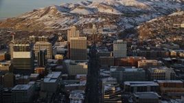 5.5K aerial stock footage of following State Street through Downtown Salt Lake City toward the state capitol at sunset in winter, Utah Aerial Stock Footage | AX127_136E