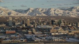 5.5K aerial stock footage of orbiting Downtown Salt Lake City at sunset with winter snow, Utah Aerial Stock Footage | AX127_149
