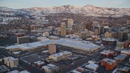 5.5K aerial stock footage of Salt Palace and Downtown Salt Lake City buildings with winter snow at sunset, Utah Aerial Stock Footage | AX127_160