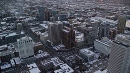 5.5K aerial stock footage orbit office buildings in Downtown Salt Lake City at sunset with winter snow, Utah Aerial Stock Footage | AX127_166