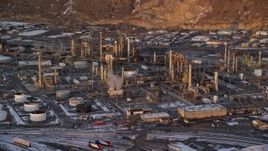 5.5K aerial stock footage of the Tesoro Refinery in Salt Lake City at sunset with winter snow, Utah Aerial Stock Footage | AX127_167E