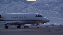5.5K aerial stock footage of tracking taxiing civilian jet at SLC Airport with winter snow at sunset, Utah Aerial Stock Footage | AX128_001E