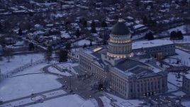 5.5K aerial stock footage of orbiting the Utah State Capitol with flag flying and winter snow at twilight, Salt Lake City Aerial Stock Footage | AX128_009