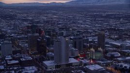 5.5K aerial stock footage orbit Church Office Building and temple in Downtown Salt Lake City with winter snow at twilight, Utah Aerial Stock Footage | AX128_019