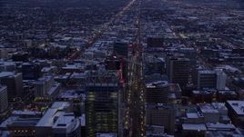 5.5K aerial stock footage of following Main Street over office buildings in Downtown Salt Lake City, Utah in winter at twilight Aerial Stock Footage | AX128_025E