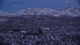 5.5K aerial stock footage of Salt Lake City suburban neighborhoods near Liberty Park with winter snow at twilight, Utah Aerial Stock Footage | AX128_030