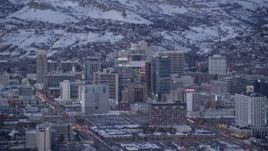 5.5K aerial stock footage of Downtown SLC buildings with winter snow on rooftops at twilight, Utah Aerial Stock Footage | AX128_032