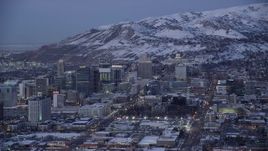 5.5K aerial stock footage orbit State Street in Downtown Salt Lake City, with view of the capitol and winter snow at twilight, Utah Aerial Stock Footage | AX128_037