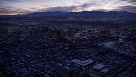 5.5K aerial stock footage orbit northeast of Downtown Salt Lake City and the Utah State Capitol with winter snow at twilight Aerial Stock Footage | AX128_053E