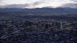 5.5K aerial stock footage of a wide orbit of Downtown Salt Lake City, Utah with winter snow at twilight Aerial Stock Footage | AX128_055