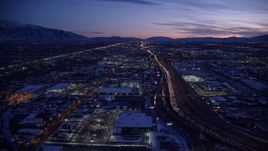 5.5K aerial stock footage fly over shopping center, approach freeway with heavy traffic at twilight, Salt Lake City, Utah Aerial Stock Footage | AX128_065E