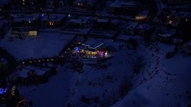 5.5K aerial stock footage approach a home decorated for Christmas with winter snow at night, Salt Lake City, Utah Aerial Stock Footage | AX128_077