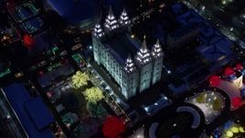 5.5K aerial stock footage bird's eye orbit of Salt Lake Temple with colorfully lit trees with winter snow at night, Downtown SLC, Utah Aerial Stock Footage | AX128_081E